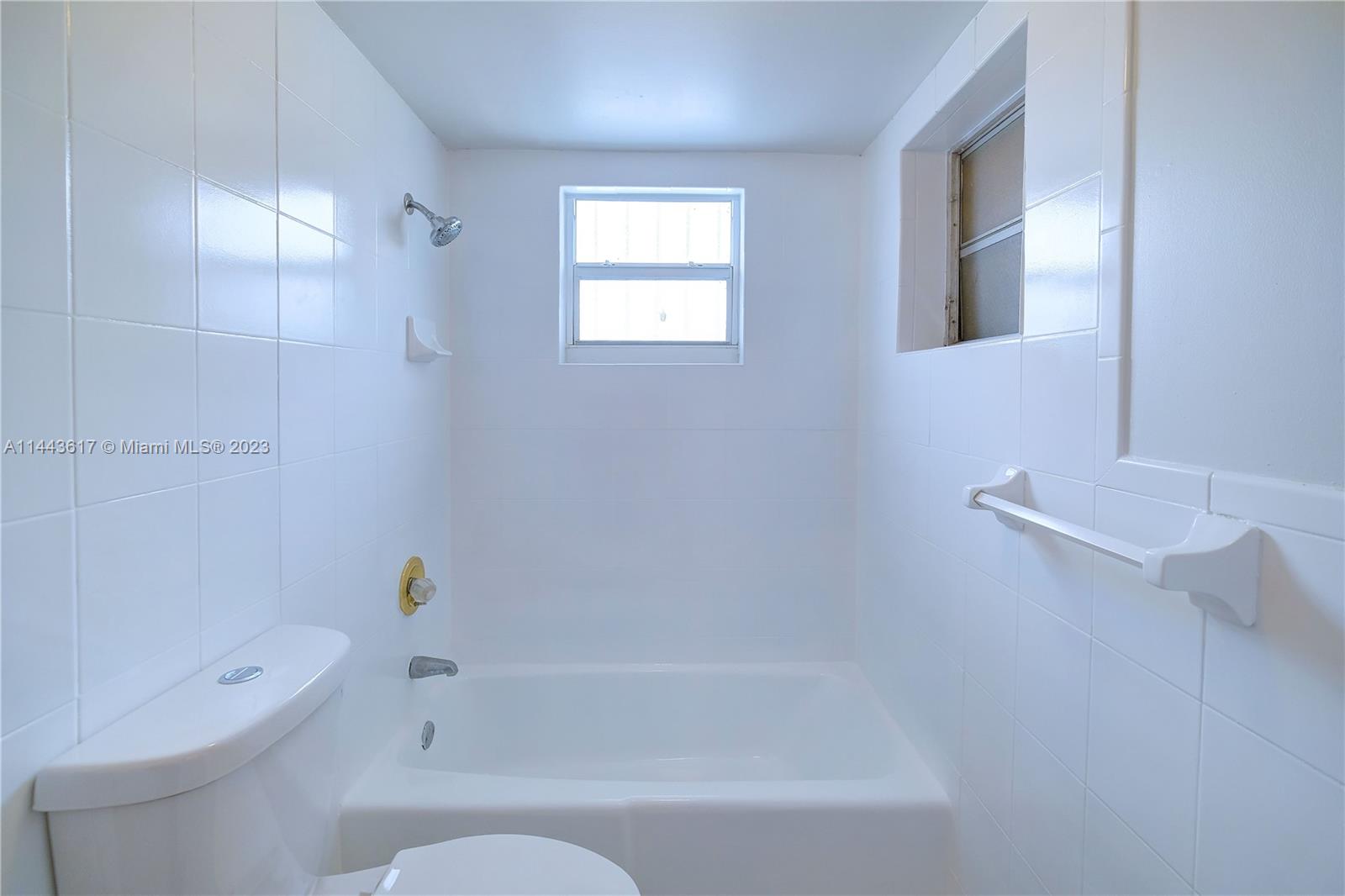 4640 Northwest 7th Street, Unit TOP Miami, FL 33126 - Photo 22 of 23 a bathroom with a bathtub and a shower