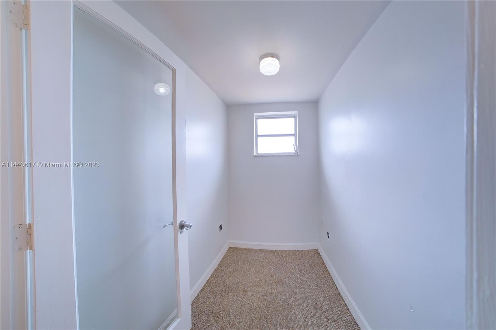 4640 Northwest 7th Street, Unit TOP Miami, FL 33126 - Photo 23 of 23 a view of an empty room and a window