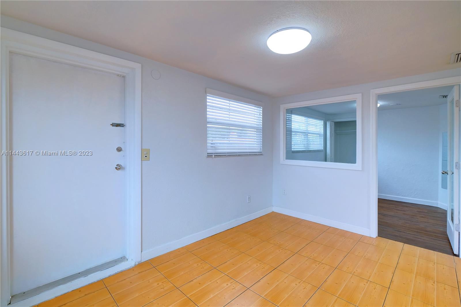 4640 Northwest 7th Street, Unit TOP Miami, FL 33126 - Photo 4 of 23 a view of a room with wooden floor and a window