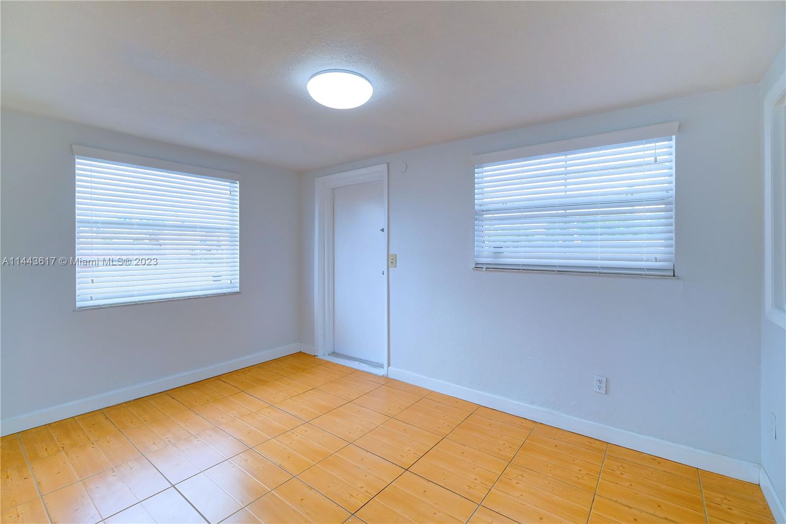 4640 Northwest 7th Street, Unit TOP Miami, FL 33126 - Photo 5 of 23 a view of empty room with window
