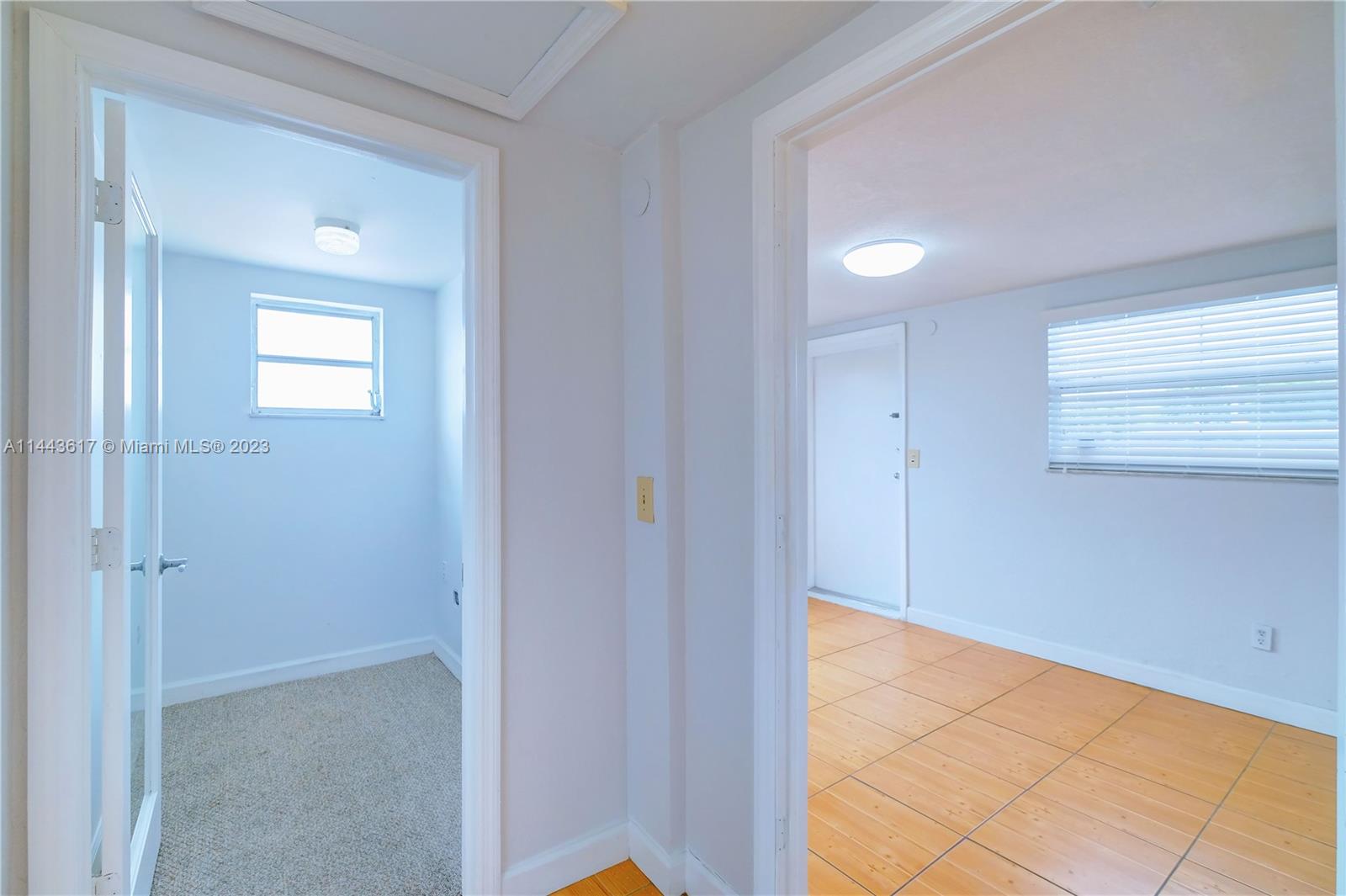 4640 Northwest 7th Street, Unit TOP Miami, FL 33126 - Photo 8 of 23 a view of an empty room with window and wooden floor
