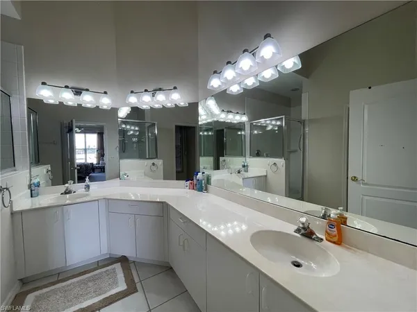 a bathroom with a sink vanity and mirror