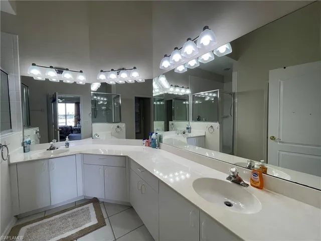 a bathroom with a sink vanity and mirror