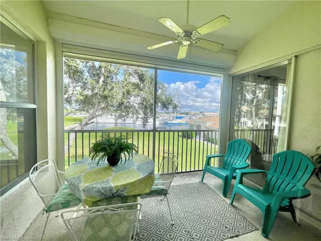 a living room with furniture a flat screen tv and a large window