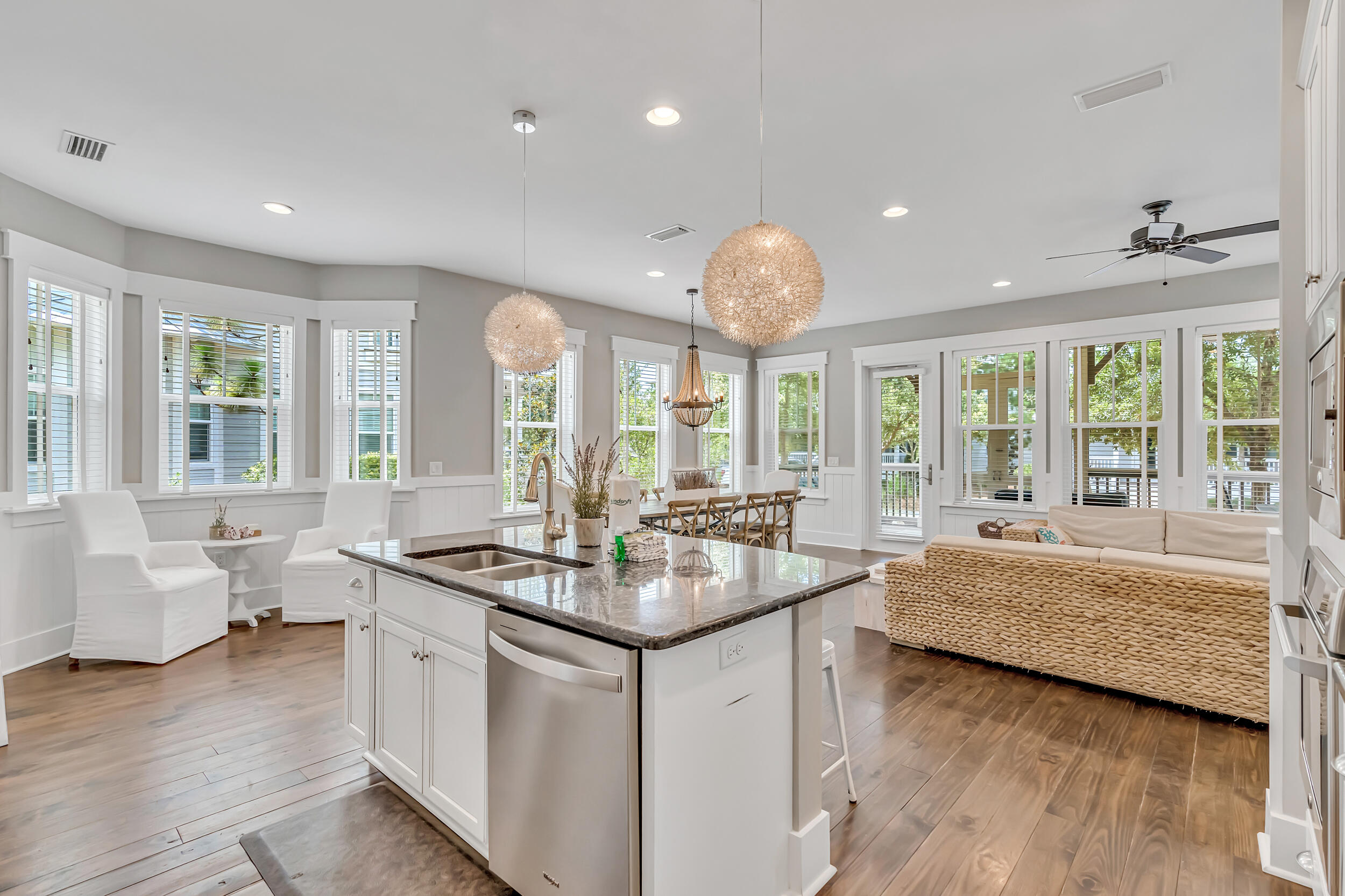 679 Flatwoods Forest Loop Santa Rosa Beach, FL 32459 - Photo 11 of 46 a room with kitchen island granite countertop a sink and wooden floors