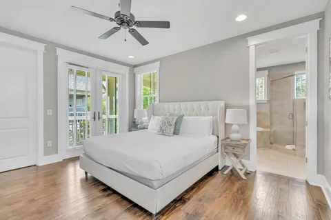 a bedroom with a large bed and a chandelier