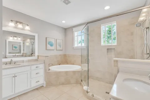 a spacious bathroom with a tub sink toilet and a shower