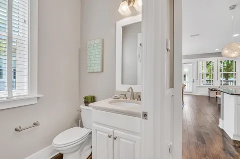 a bathroom with a sink toilet and a mirror