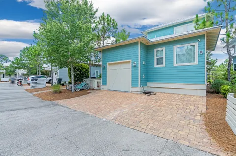 a view of a house with a yard and garage