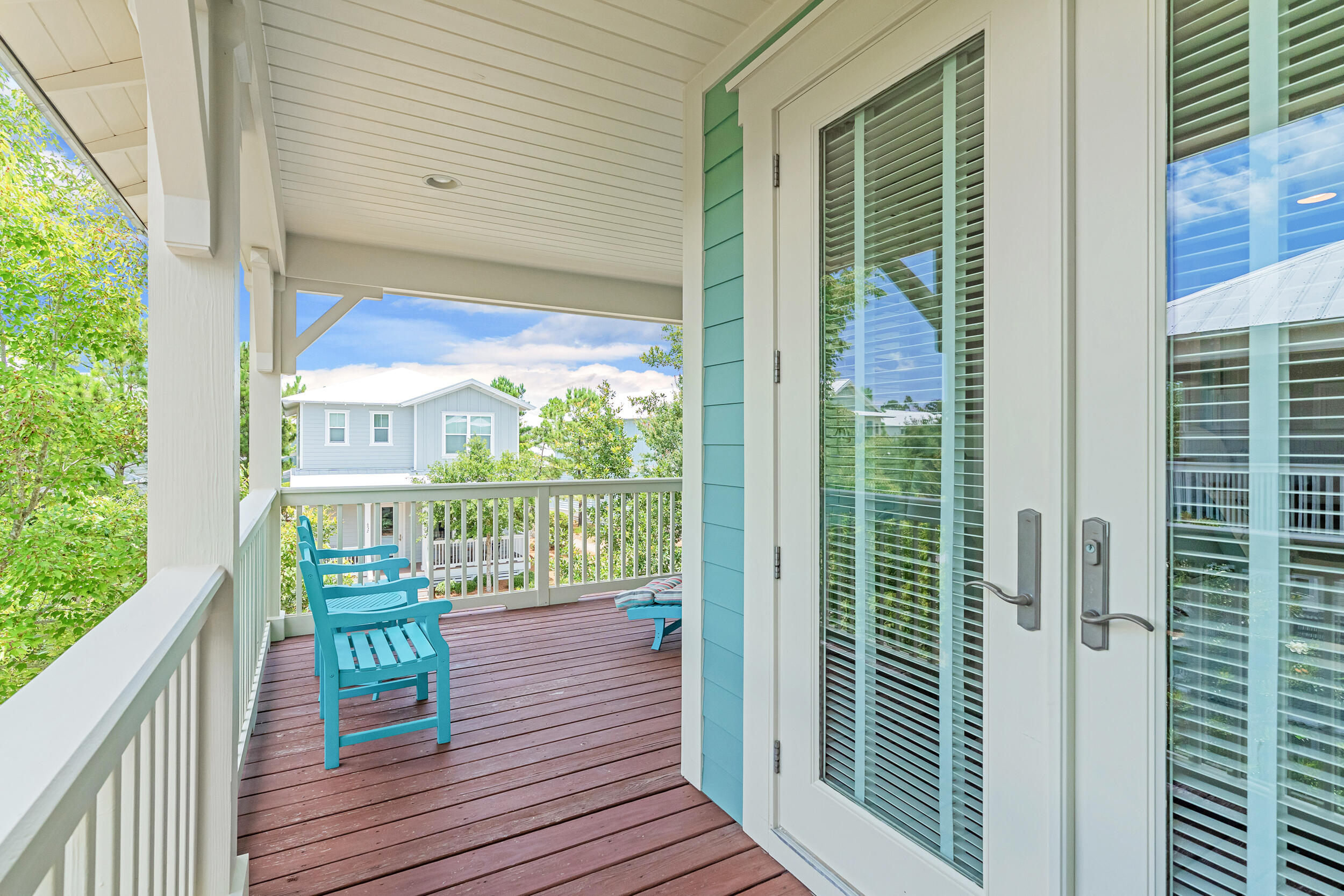 679 Flatwoods Forest Loop Santa Rosa Beach, FL 32459 - Photo 5 of 46 a view of a balcony with floor to ceiling windows with wooden floor
