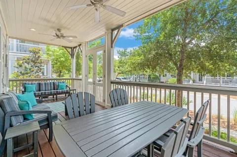 a view of a patio with a table chairs and a backyard