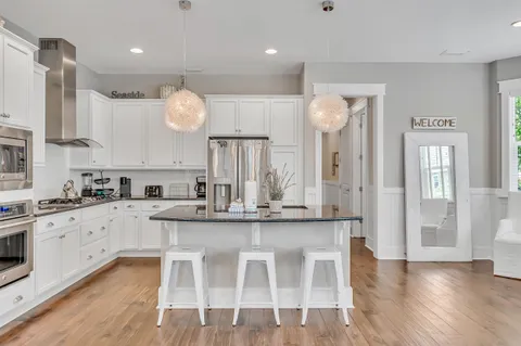 a large kitchen with a table and chairs