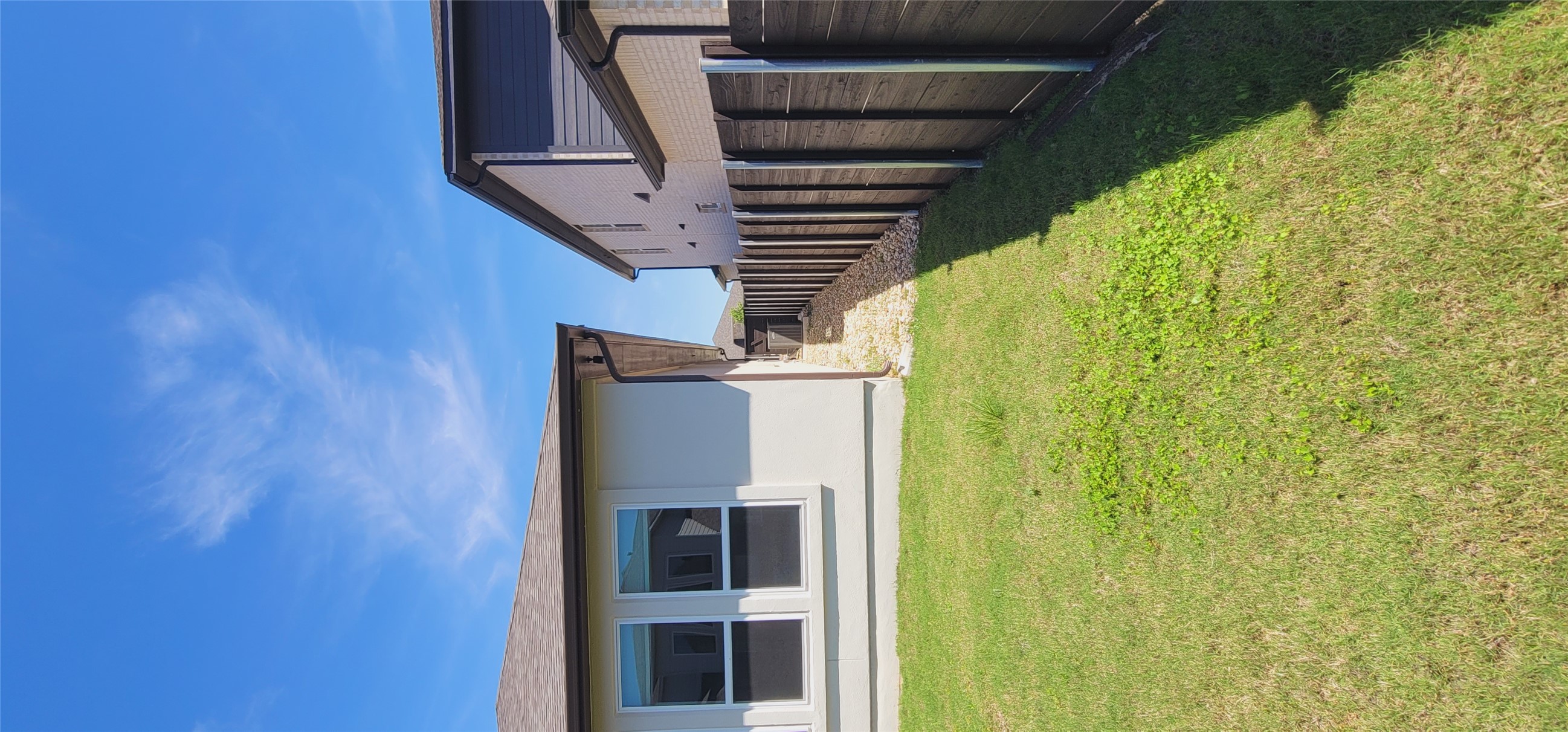 716 Leeward Pass Leander, TX 78641 - Photo 24 of 26 A well-maintained side yard with green lawn and a secure perimeter fence.