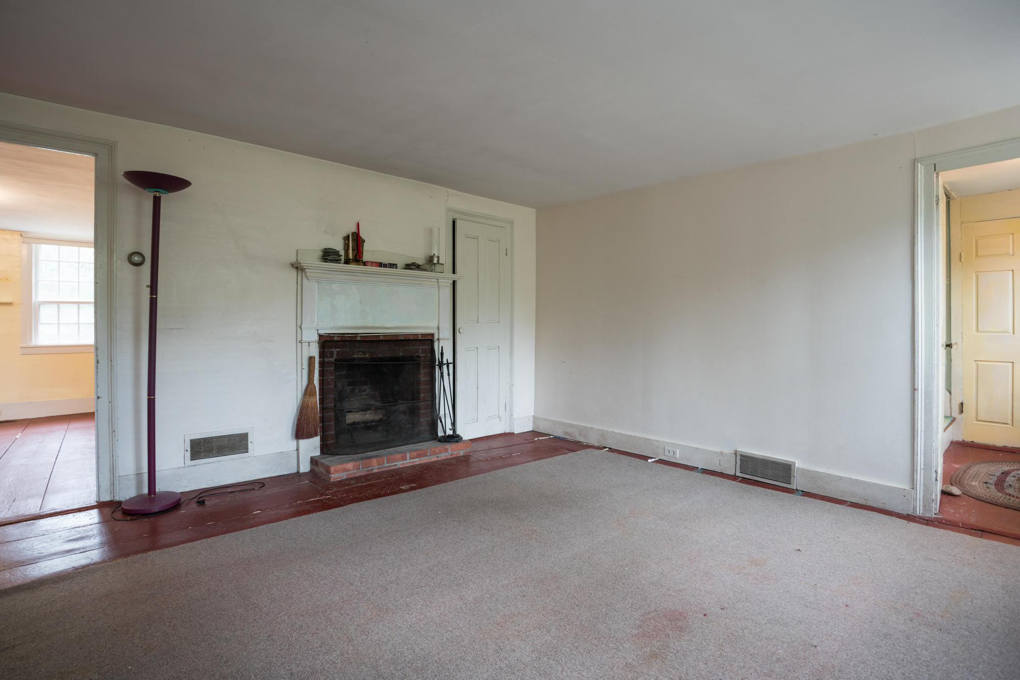 155 Old County Road Truro, MA 02666 - Photo 11 of 27 an empty room with fireplace and windows