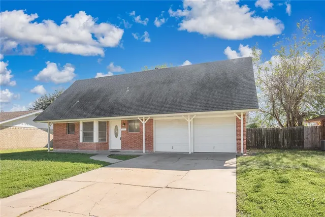 a view of house with backyard