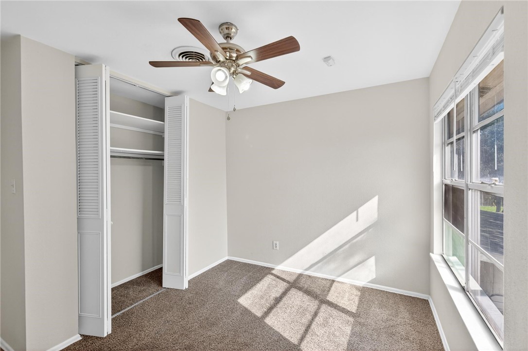1104 Polaris Drive Portland, TX 78374 - Photo 19 of 39 a view of an empty room with wooden floor and a ceiling fan