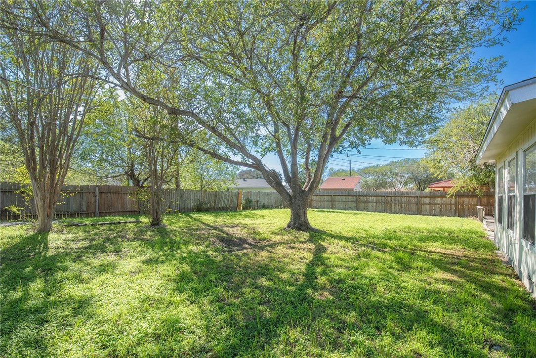 1104 Polaris Drive Portland, TX 78374 - Photo 31 of 39 a backyard of a house with lots of plants and large tree