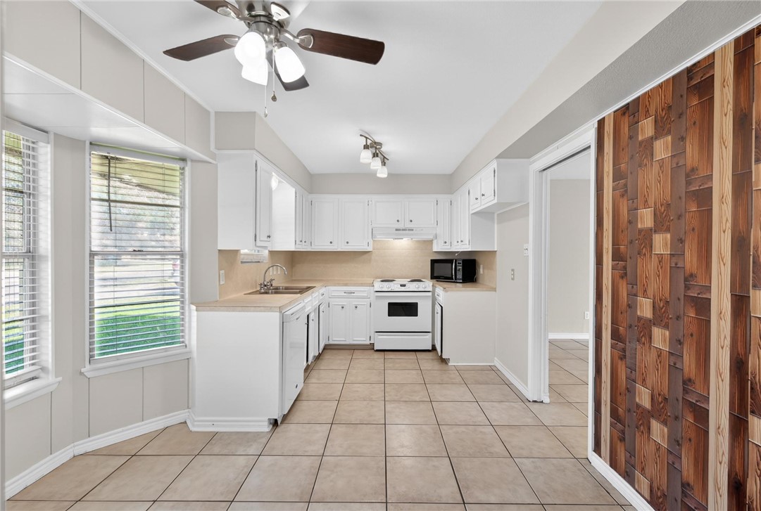1104 Polaris Drive Portland, TX 78374 - Photo 8 of 39 a kitchen with stainless steel appliances a refrigerator sink and microwave