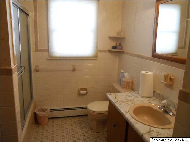 19 Oakfield Road Toms River, NJ 08757 - Photo 12 of 15 a bathroom with a sink a toilet and a mirror
