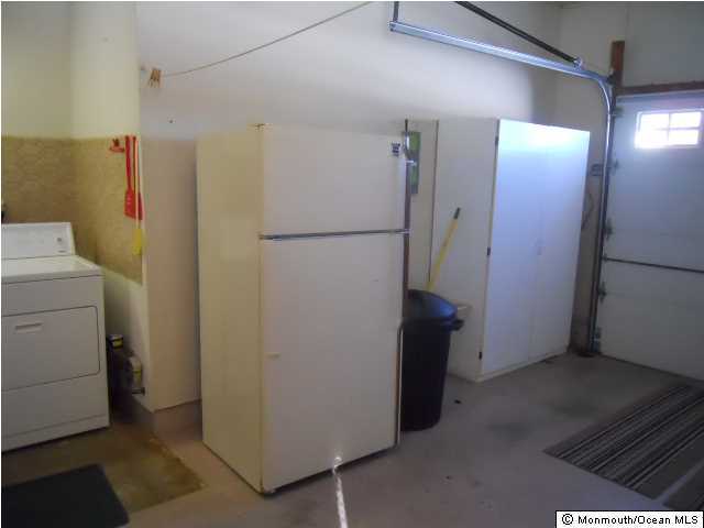 19 Oakfield Road Toms River, NJ 08757 - Photo 14 of 15 a view of a storage & utility room with a refrigerator