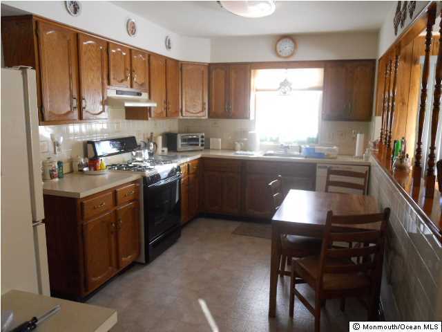 19 Oakfield Road Toms River, NJ 08757 - Photo 5 of 15 a kitchen with stainless steel appliances granite countertop a sink a stove a refrigerator cabinets and a window