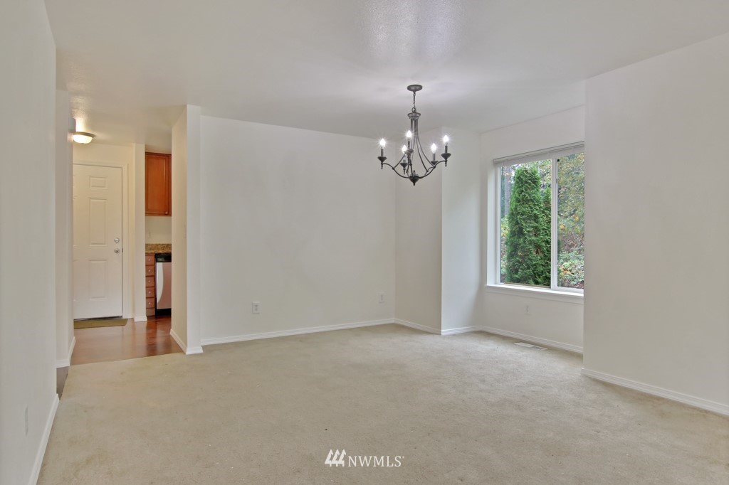 15925 Spanaway Loop Road South Spanaway, WA 98387 - Photo 5 of 14 a view of an empty room with window and chandelier fan