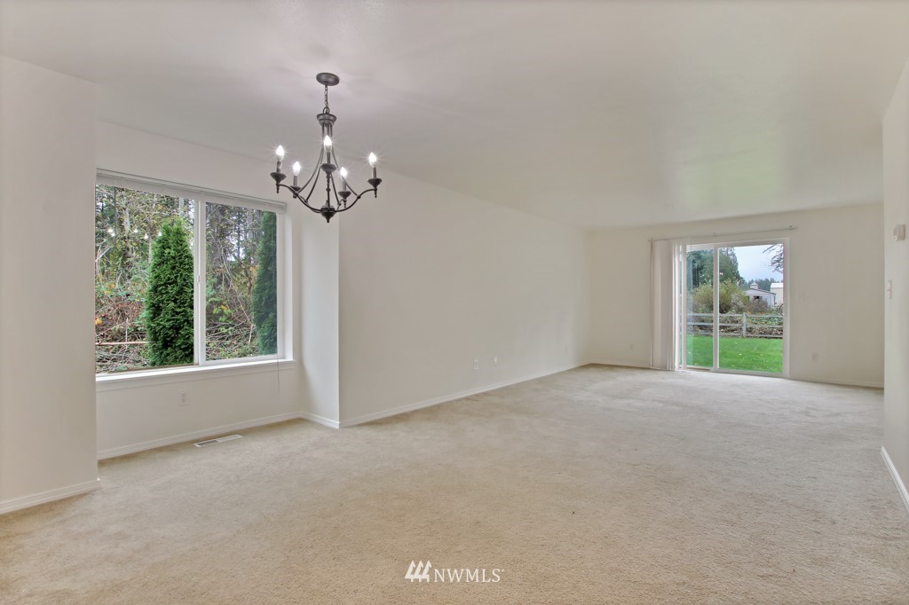 15925 Spanaway Loop Road South Spanaway, WA 98387 - Photo 6 of 14 a view of a big room with windows and chandelier