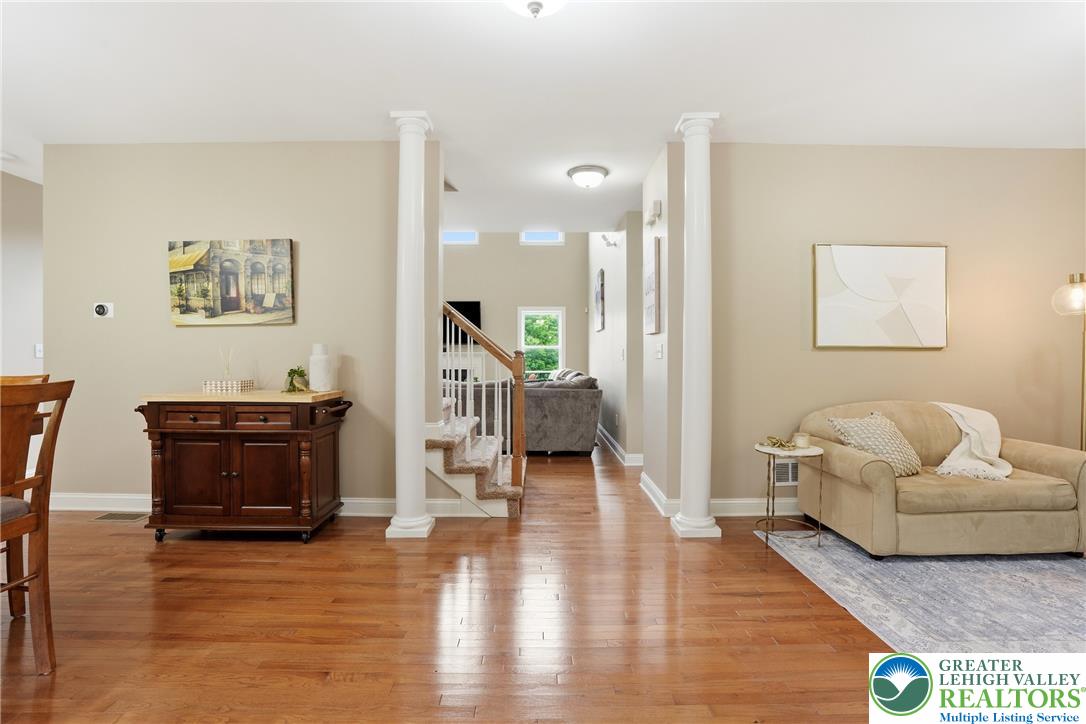 1212 Miller Road Wind Gap, PA 18091 - Photo 11 of 72 Warm hardwood floors extend throughout this inviting open living space, offering a seamless flow to the adjacent staircase.