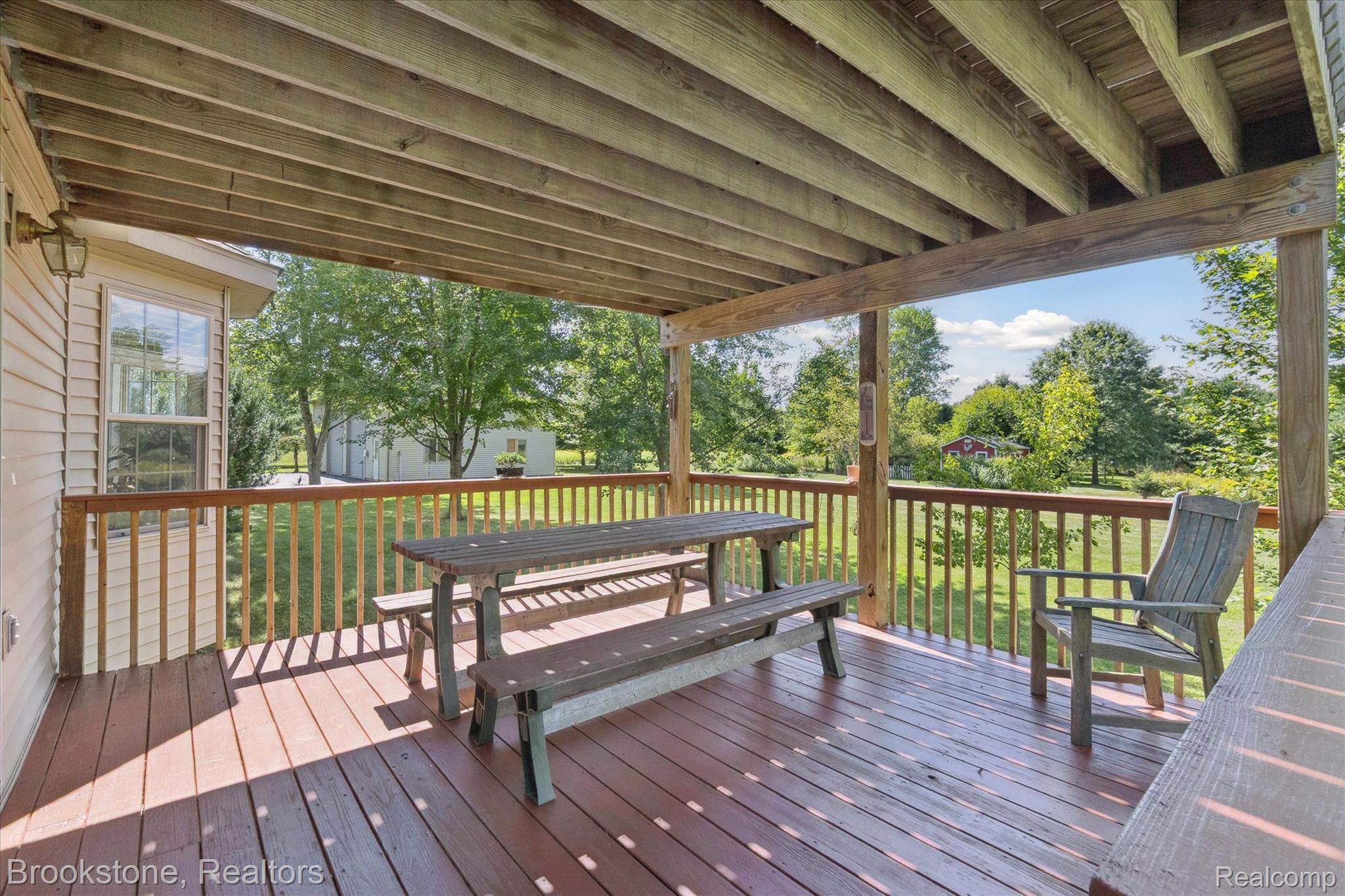 13962 South Beardslee Road Perry, MI 48872 - Photo 41 of 56 Wooden terrace featuring a storage shed and outdoor dining area
