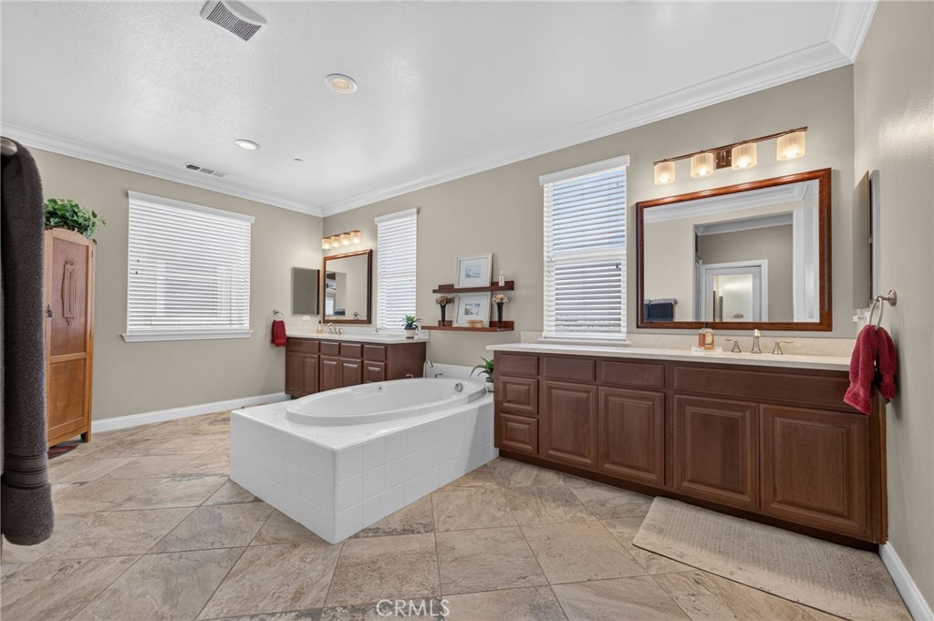 31749 Country View Road Temecula, CA 92591 - Photo 36 of 68 a large spacious bathroom with a granite countertop tub sink and mirror