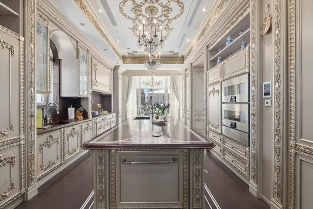 a view of a patio with couches table and chairs under an umbrella with a fire pit