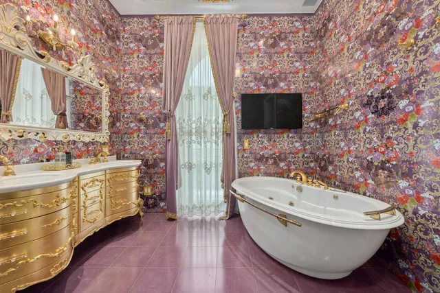 a dining room with furniture and a large window