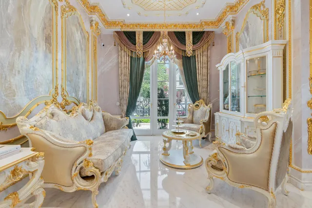 a view of a dining room with furniture and a chandelier