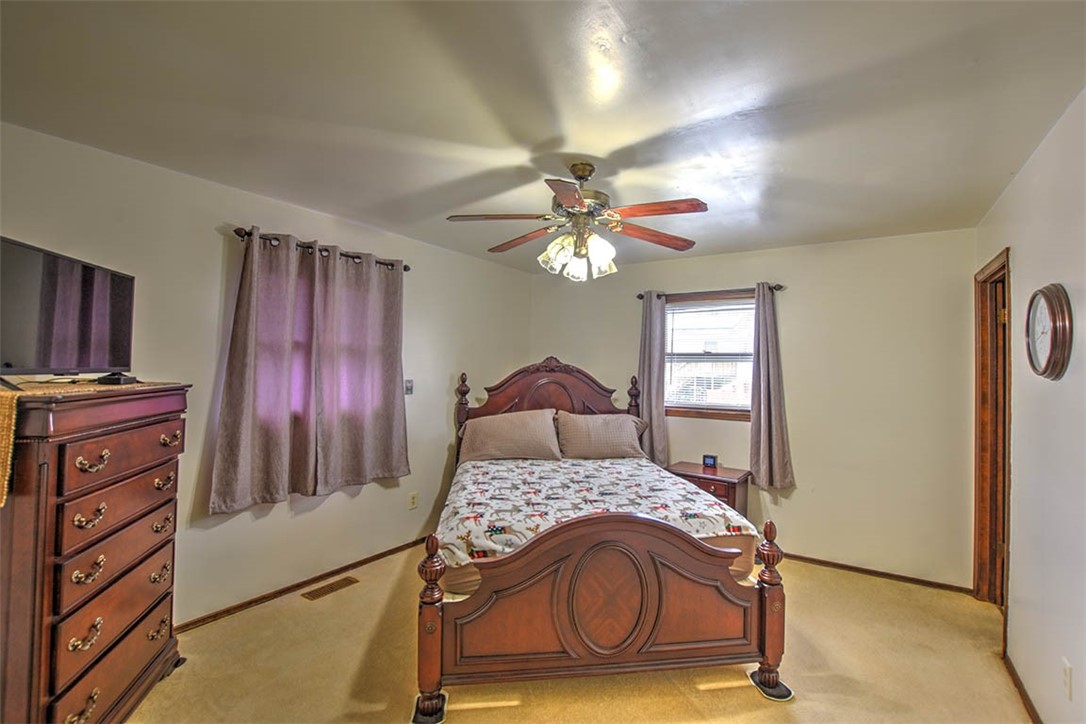 4425 Butler Drive Decatur, IL 62526 - Photo 14 of 22 a bedroom with a bed and a chandelier