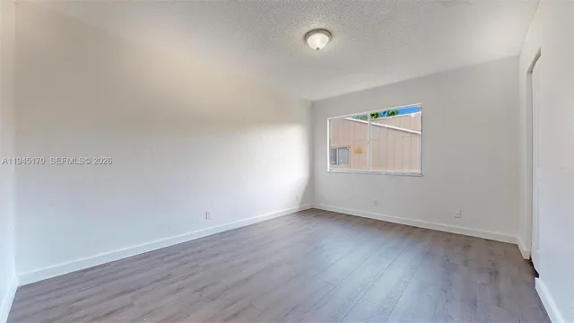 an empty room with wooden floor