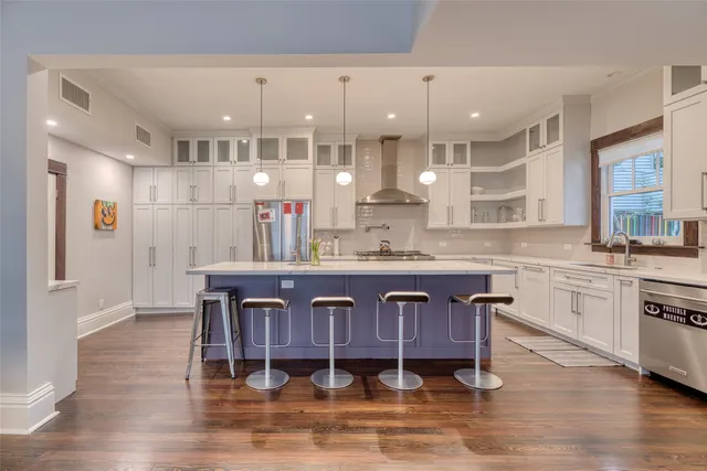 a kitchen with stainless steel appliances granite countertop a stove and a refrigerator