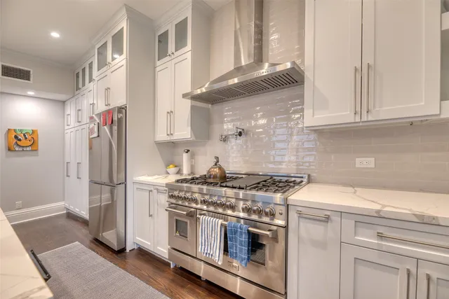 a spacious bathroom with a double vanity sink a mirror and a bathtub