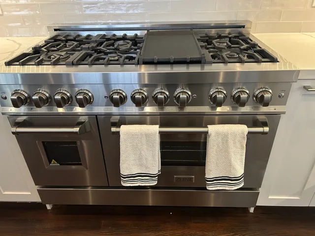 a kitchen with a sink and a stove top oven