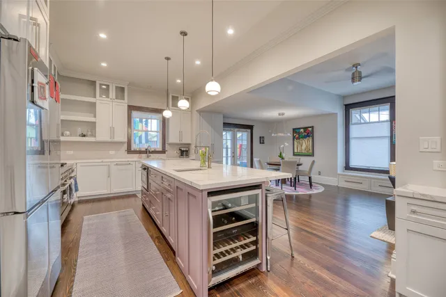 an empty room with windows and cabinet