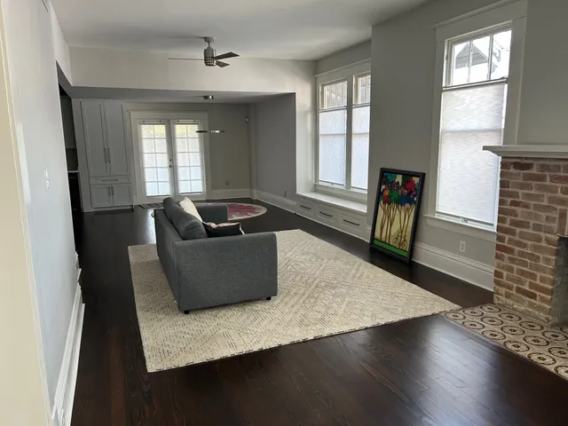 a kitchen with stainless steel appliances granite countertop a kitchen island hardwood floor sink stove and wooden cabinets