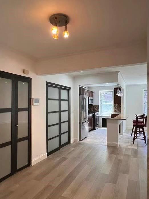 85-11 34th Avenue, Unit 2R Queens, NY 11372 - Photo 1 of 4 a view of a livingroom with furniture and chandelier
