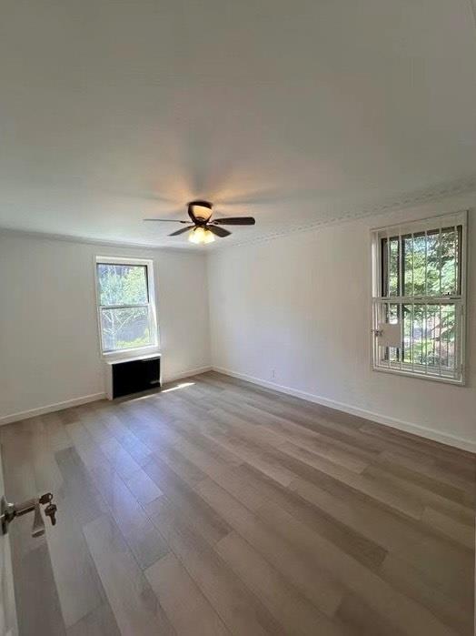 85-11 34th Avenue, Unit 2R Queens, NY 11372 - Photo 4 of 4 wooden floor in an empty room with a window