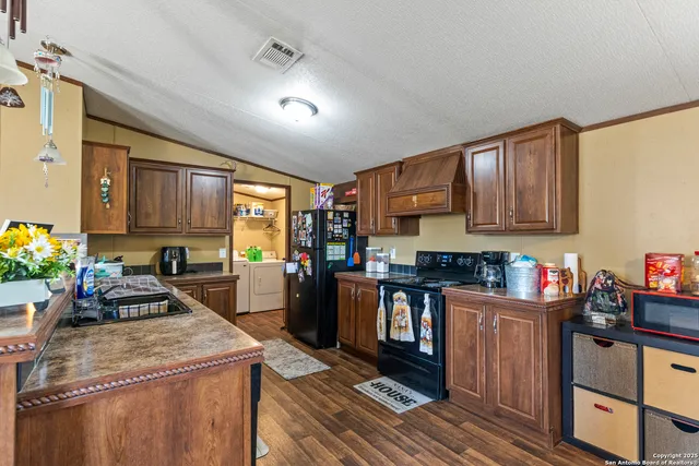 a kitchen with stainless steel appliances granite countertop sink stove top oven and cabinets