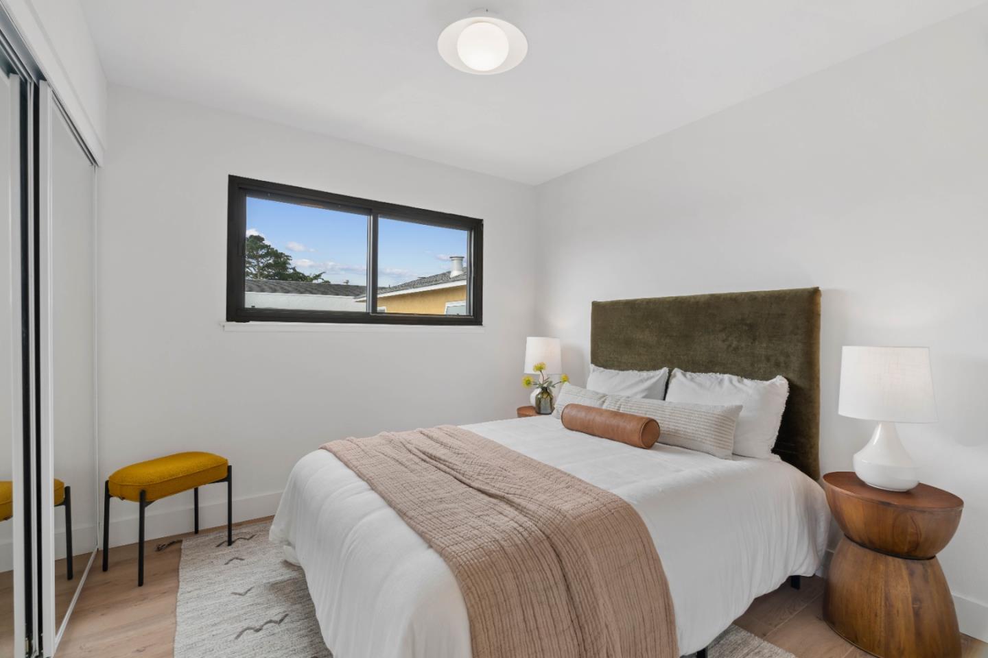 289 Dennis Drive Daly City, CA 94015 - Photo 22 of 45 a bedroom with a bed and a lamp next to a window