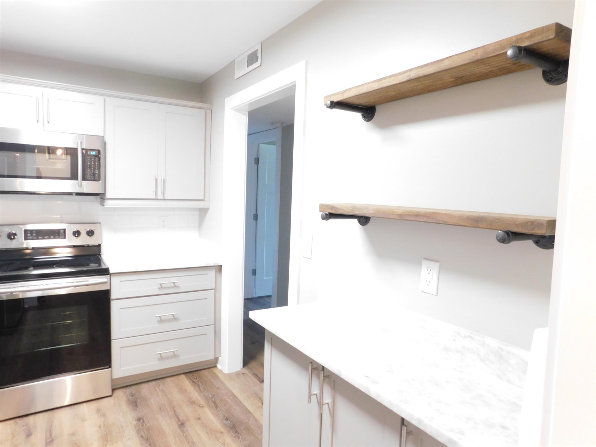 1900 Richard Jones Road, Unit R4 Nashville, TN 37215 - Photo 6 of 13 a kitchen with a cabinets and a stove top oven