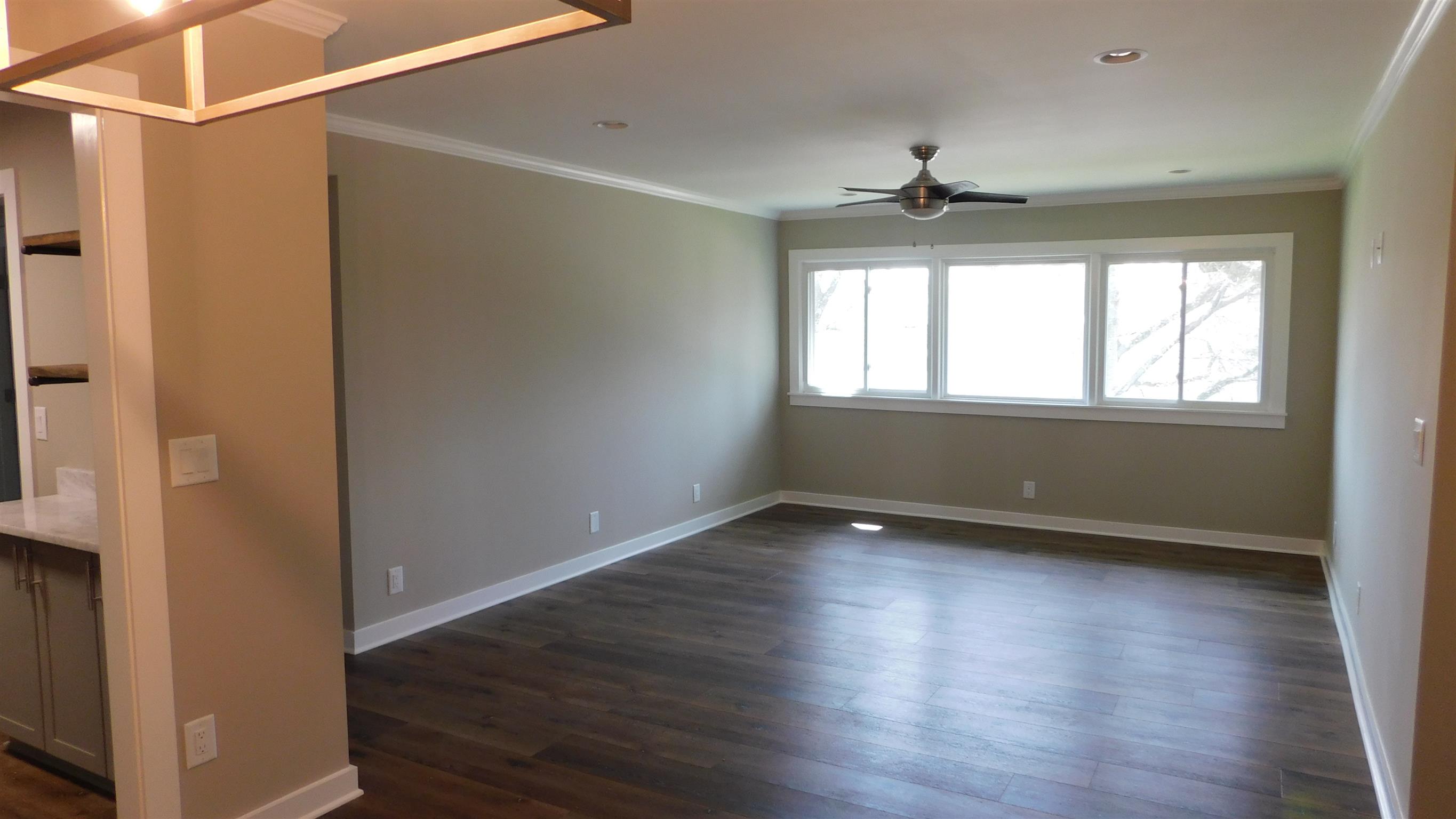 1900 Richard Jones Road, Unit R4 Nashville, TN 37215 - Photo 9 of 13 an empty room with wooden floor ceiling fan and windows
