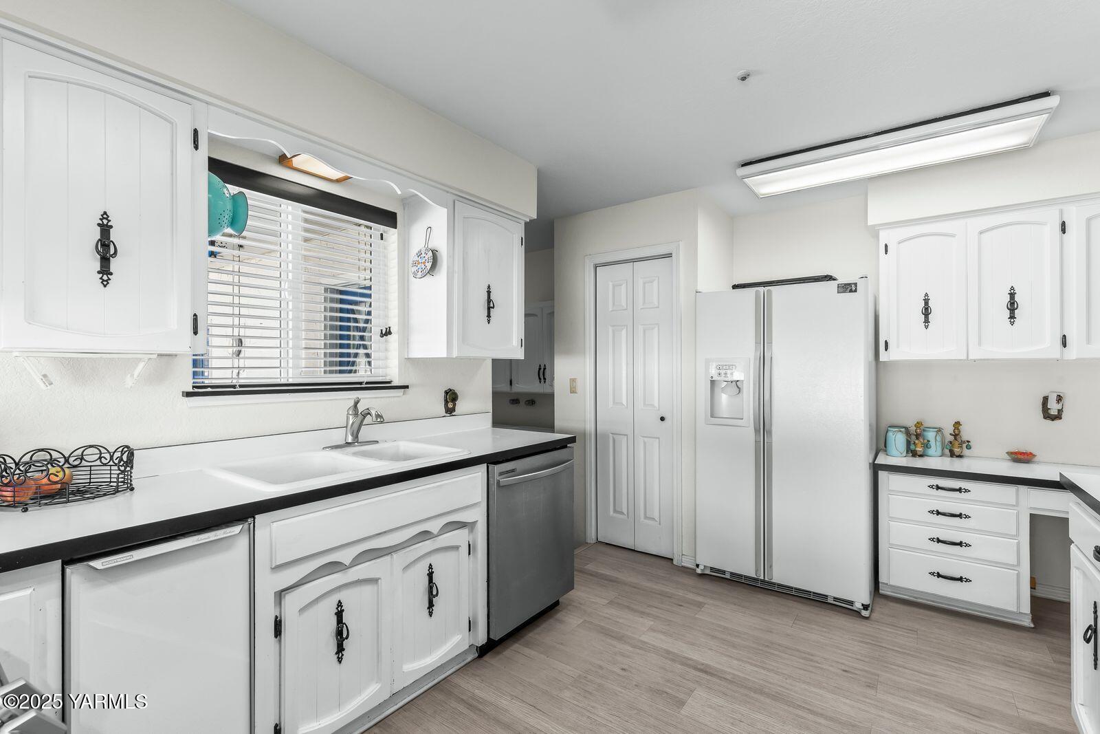 5503 Norman Road Yakima, WA 98901 - Photo 16 of 35 a kitchen with white cabinets and wooden floor
