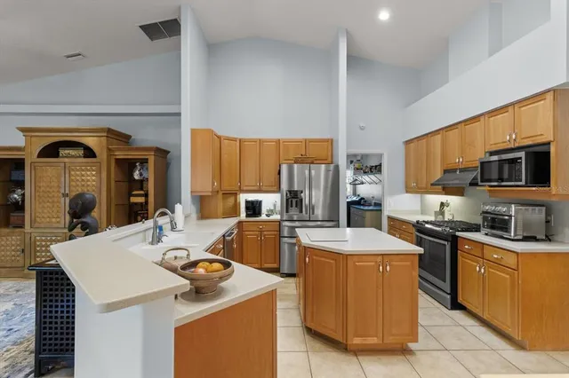 a kitchen with stainless steel appliances a sink stove and refrigerator