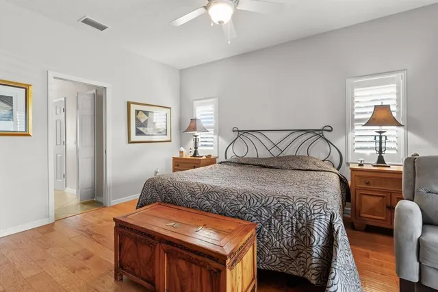 a bedroom with a bed and large windows