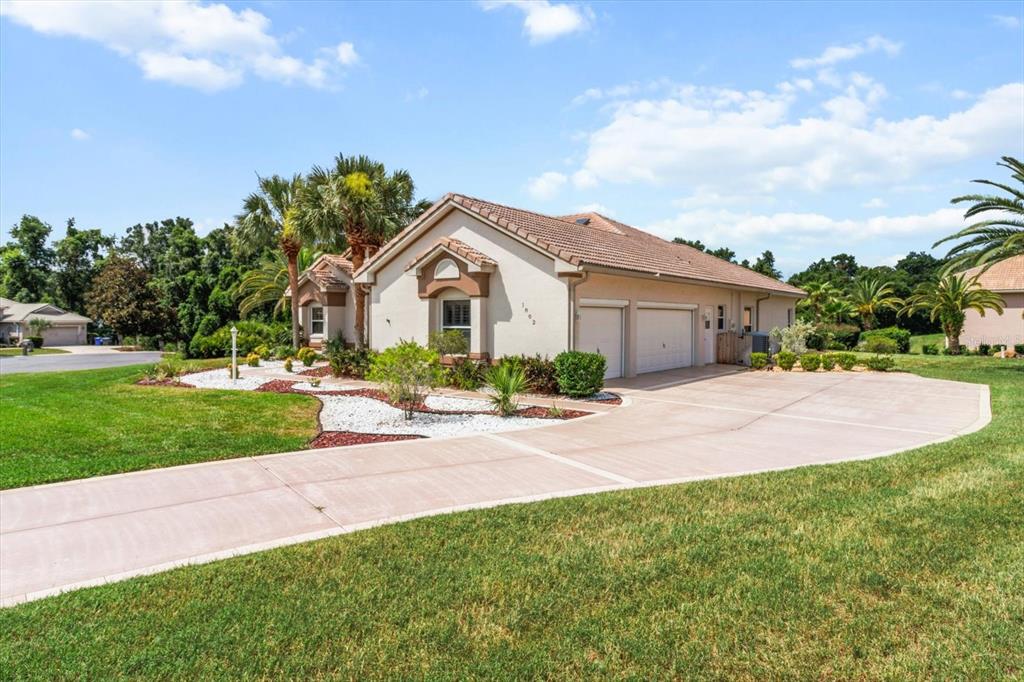 1802 North Musial Point Hernando, FL 34442 - Photo 2 of 42 a front view of a house with a yard and potted plants